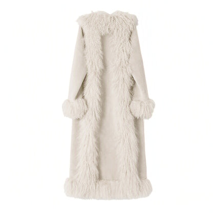 A long, cream-colored mongolain fur coat with a shawl collar, long sleeves, and matching pom-pom cuffs